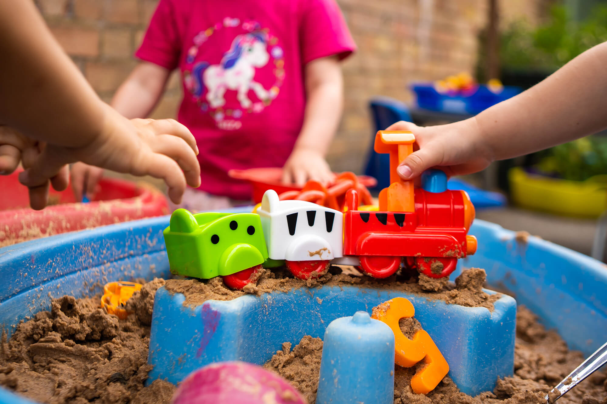 Little Bears Whiteley Village nursery children playing with outdoor toys